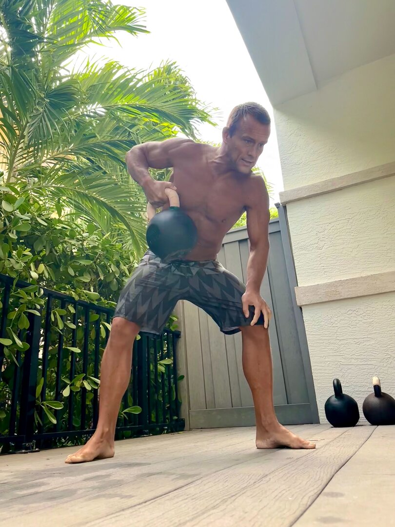 Kettlebell training outdoors in Palm Beach - holistic fitness coaching for stress resilience and functional strength