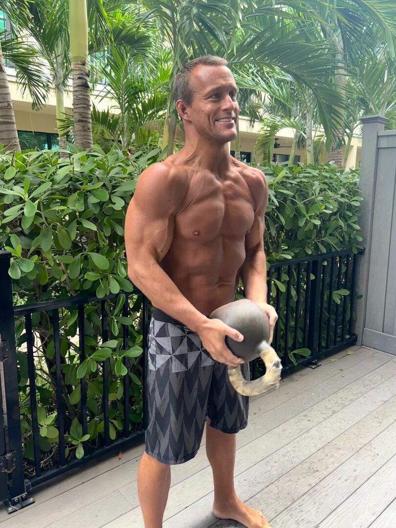 Personal trainer demonstrating kettlebell technique in Florida - stress resilience training